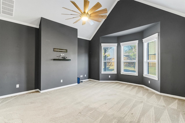 spare room featuring vaulted ceiling, ornamental molding, light carpet, and ceiling fan