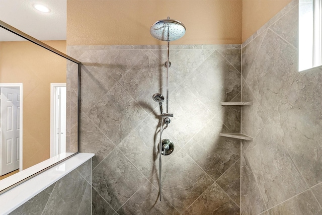 bathroom with a tile shower