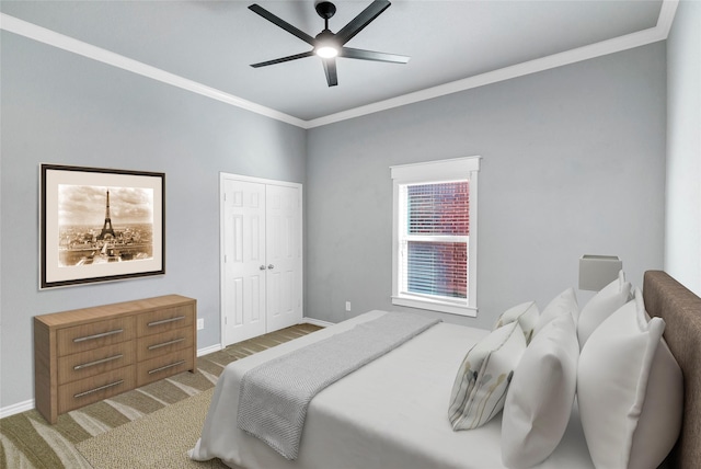 carpeted bedroom featuring ornamental molding, a closet, and ceiling fan