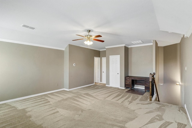 empty room featuring ornamental molding, carpet flooring, and ceiling fan