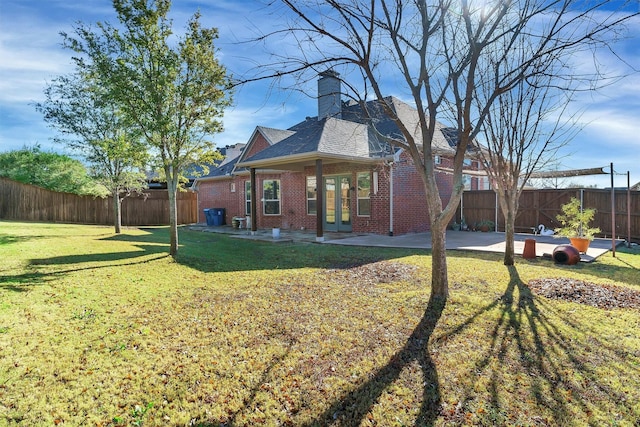 back of house with a lawn