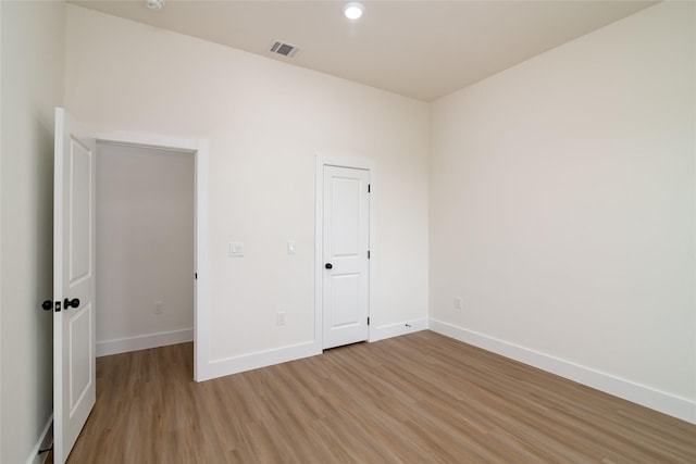 unfurnished bedroom with recessed lighting, baseboards, visible vents, and light wood-type flooring