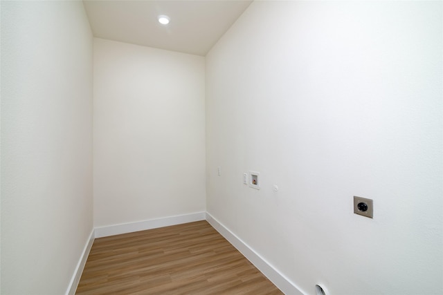 washroom with electric dryer hookup, hookup for a washing machine, and light wood-type flooring