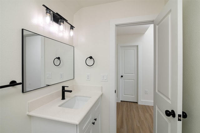 bathroom featuring hardwood / wood-style flooring and vanity