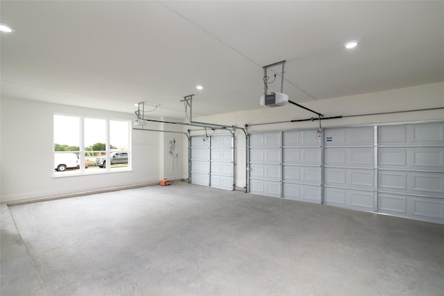 garage featuring recessed lighting and a garage door opener