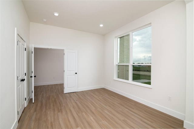 spare room featuring light wood-type flooring