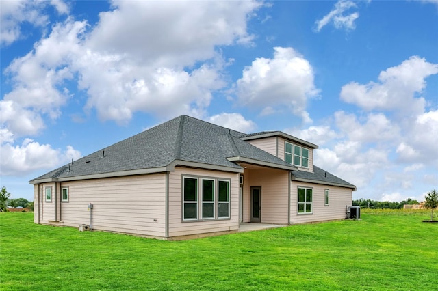 back of house with cooling unit, a lawn, and a patio area