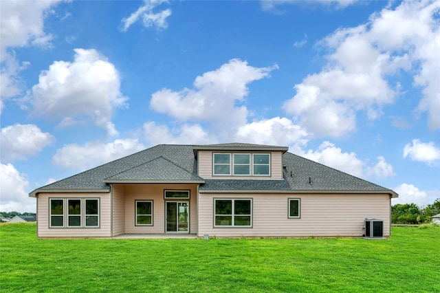 back of property with a patio, central AC, and a lawn