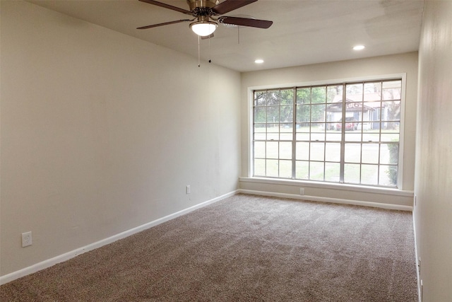 carpeted empty room featuring ceiling fan