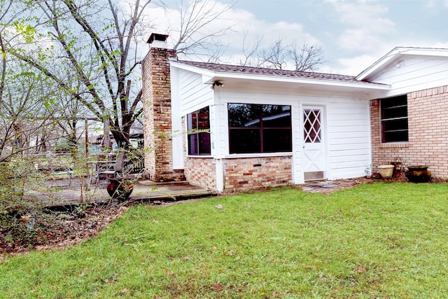 rear view of property featuring a yard