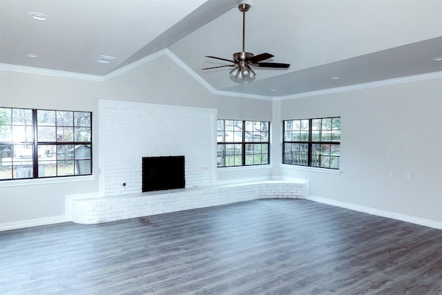 unfurnished living room with lofted ceiling, crown molding, ceiling fan, dark hardwood / wood-style floors, and a fireplace