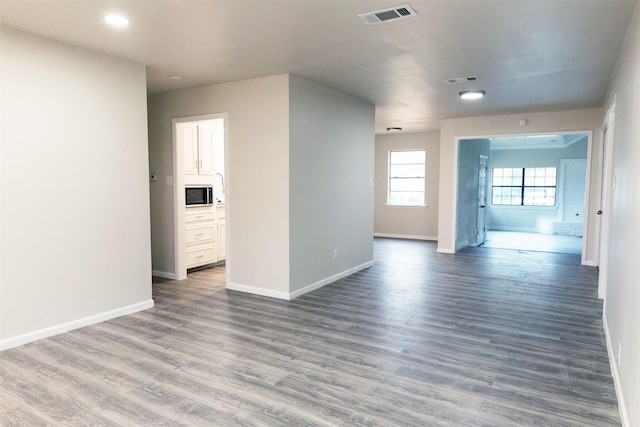 unfurnished room with dark hardwood / wood-style flooring