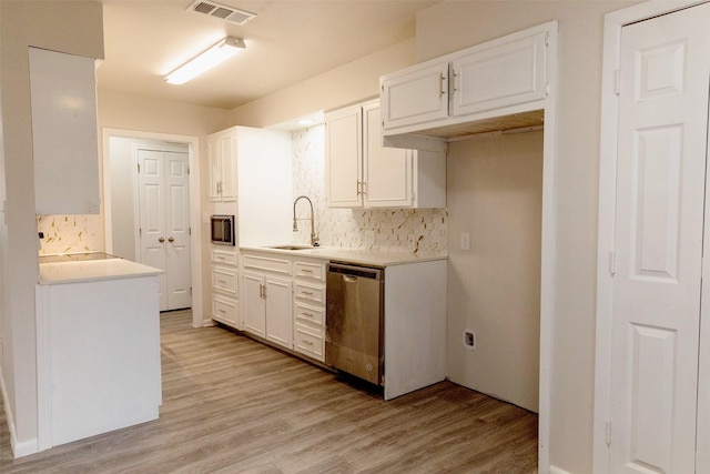 kitchen with white cabinets, sink, stainless steel appliances, and tasteful backsplash