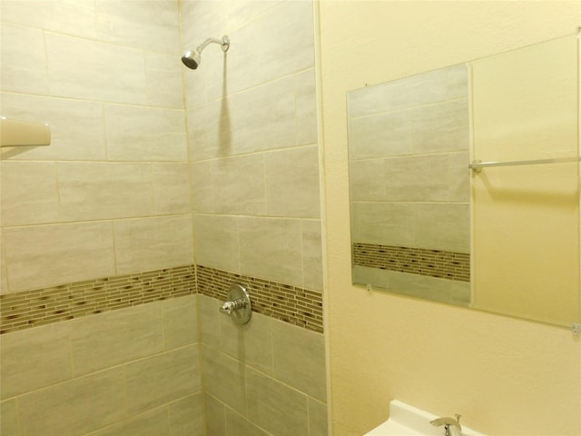 bathroom with a tile shower