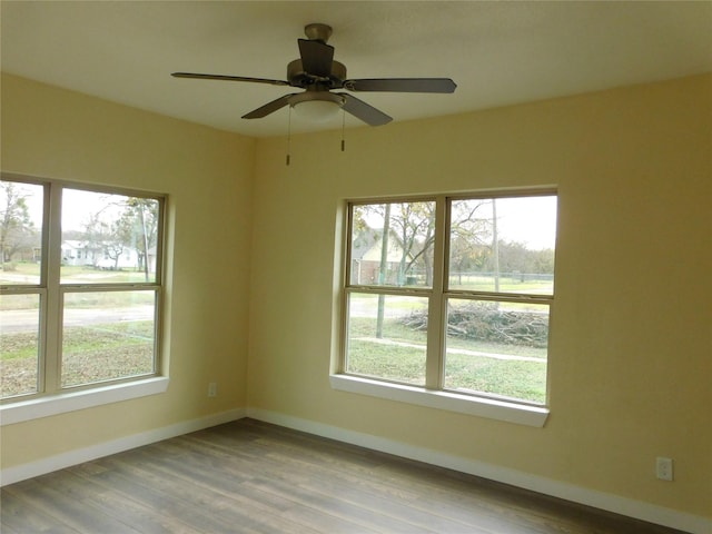 empty room featuring hardwood / wood-style flooring and ceiling fan