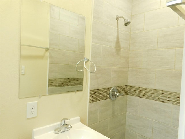 bathroom with sink and tiled shower