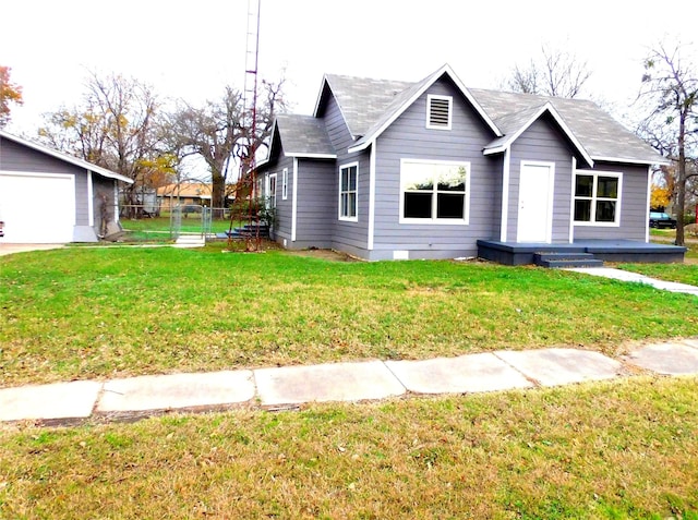 view of front of house featuring a front yard, a garage, and an outdoor structure