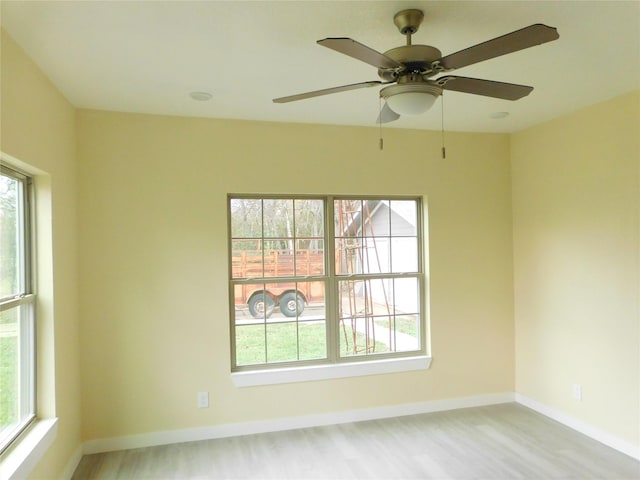 empty room with plenty of natural light and light hardwood / wood-style floors