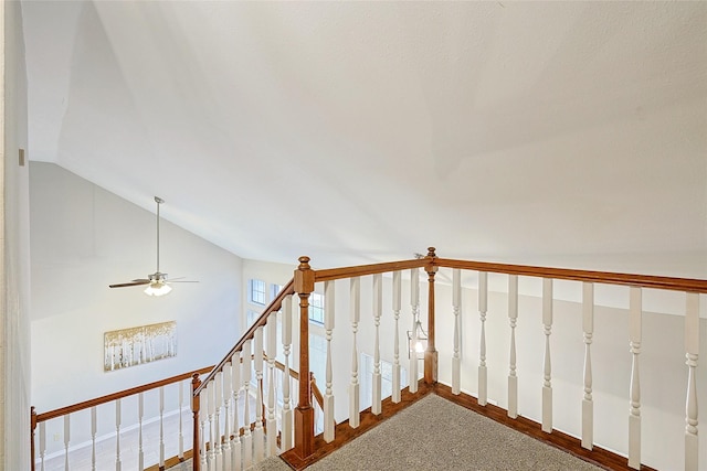 stairs with vaulted ceiling and hardwood / wood-style floors