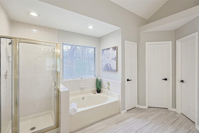 bathroom featuring shower with separate bathtub