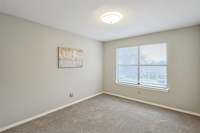 carpeted spare room with a textured ceiling