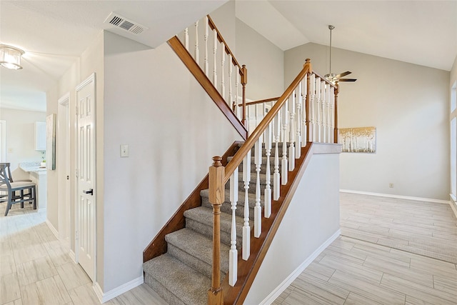 stairs with hardwood / wood-style flooring, vaulted ceiling, and ceiling fan