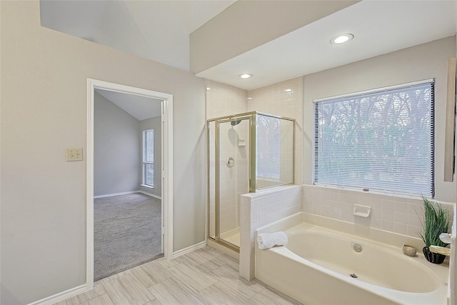 bathroom featuring independent shower and bath