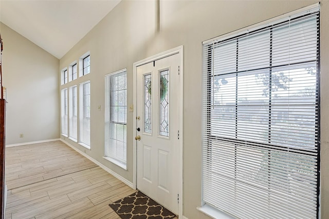 foyer featuring lofted ceiling and light hardwood / wood-style flooring