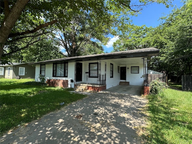 single story home featuring covered porch and a front yard