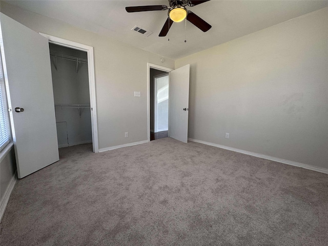 unfurnished bedroom with baseboards, visible vents, ceiling fan, a closet, and carpet flooring