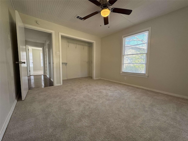 unfurnished bedroom featuring a closet, visible vents, baseboards, and carpet