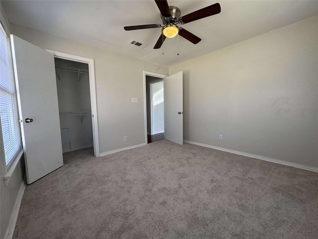 unfurnished bedroom with visible vents, ceiling fan, baseboards, carpet, and a closet