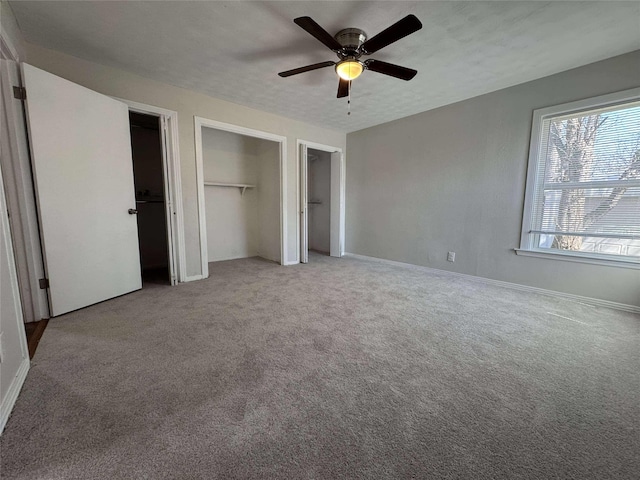 unfurnished bedroom with a textured ceiling, a ceiling fan, baseboards, and carpet floors