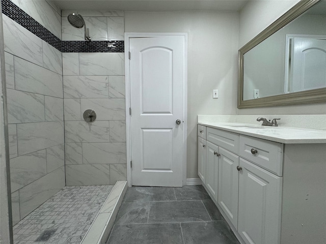 bathroom with vanity and tiled shower