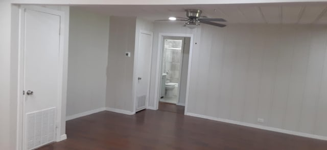 spare room featuring dark wood-type flooring and ceiling fan