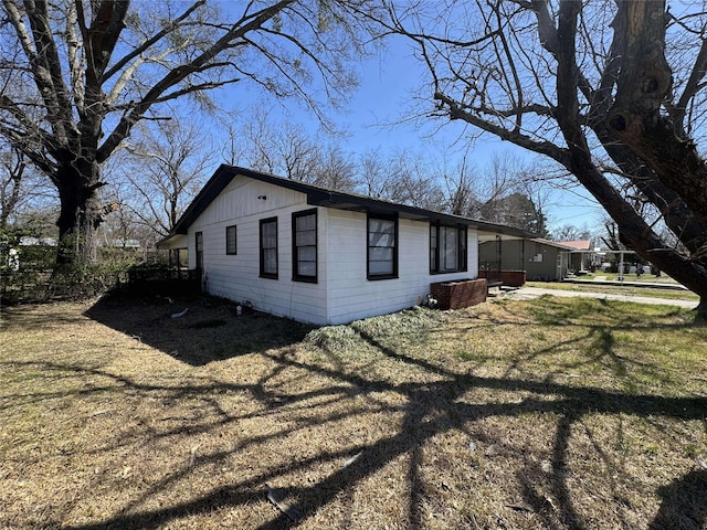 view of home's exterior featuring a lawn and board and batten siding