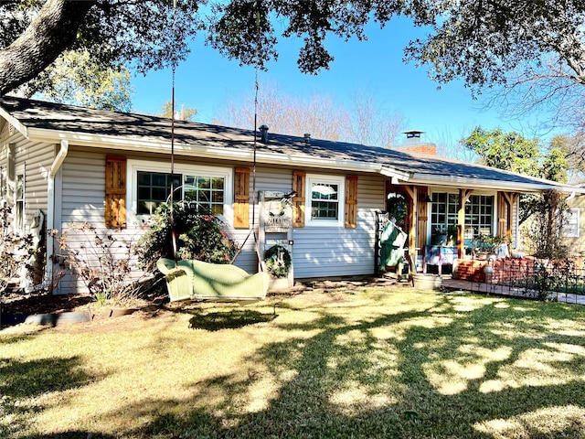 rear view of house featuring a yard