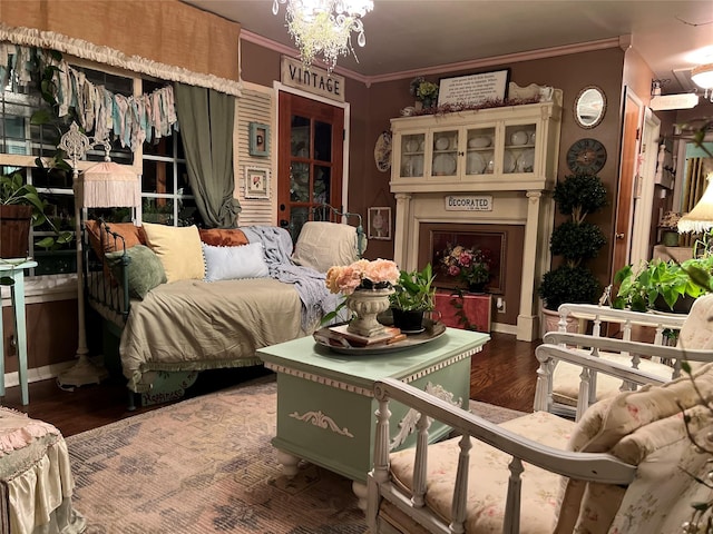 bedroom with hardwood / wood-style flooring, crown molding, and an inviting chandelier