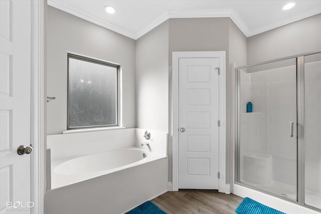 bathroom with plus walk in shower, wood-type flooring, and crown molding