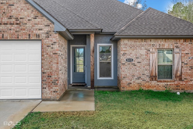 doorway to property with a yard and a garage