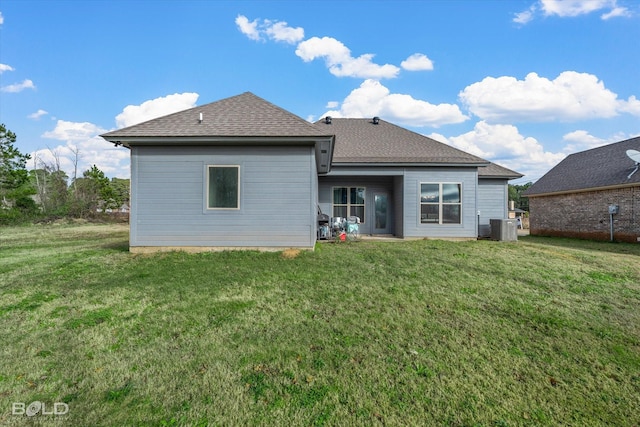 rear view of house featuring a yard and cooling unit