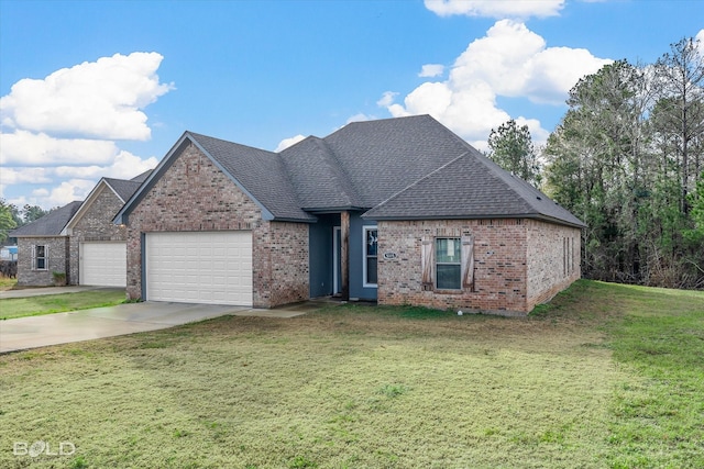 view of front of property with a garage and a front lawn