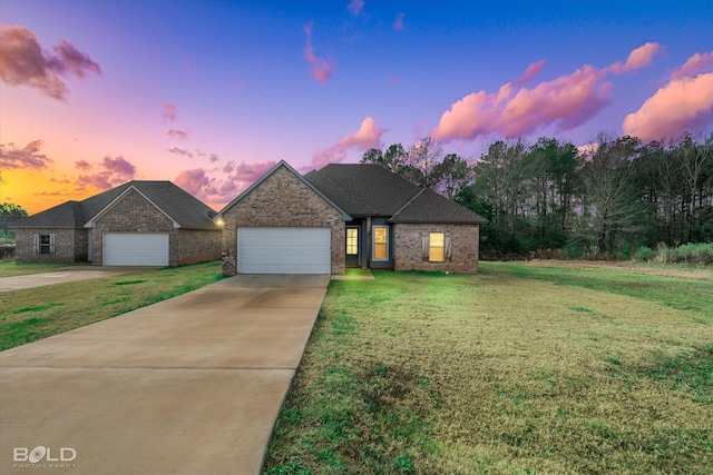 view of front of property featuring a lawn and a garage