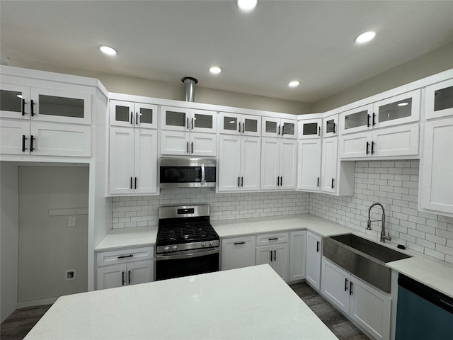 kitchen featuring white cabinetry, sink, appliances with stainless steel finishes, and tasteful backsplash