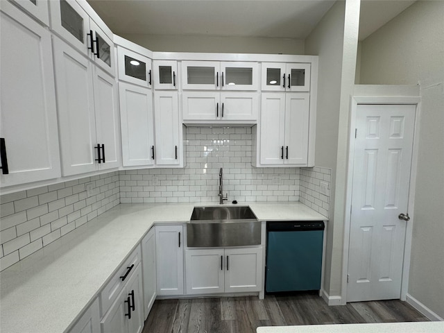 kitchen featuring dishwasher, sink, dark hardwood / wood-style floors, backsplash, and white cabinets