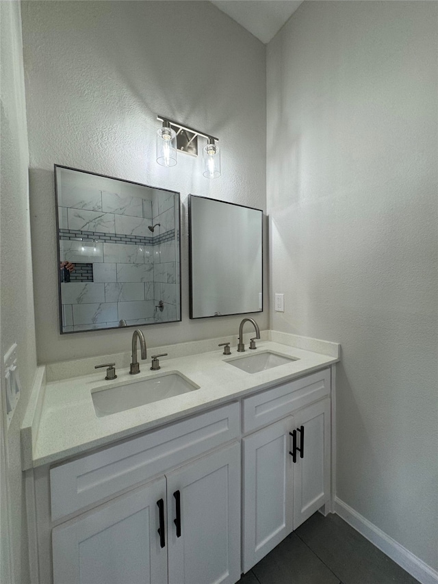 bathroom with a shower, tile patterned flooring, and vanity