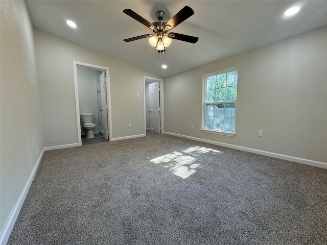 unfurnished bedroom featuring carpet flooring, ensuite bathroom, ceiling fan, and lofted ceiling