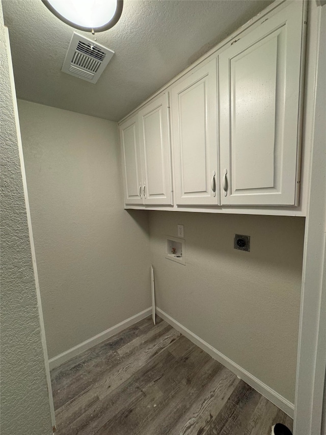 laundry room featuring cabinets, washer hookup, dark hardwood / wood-style flooring, and electric dryer hookup