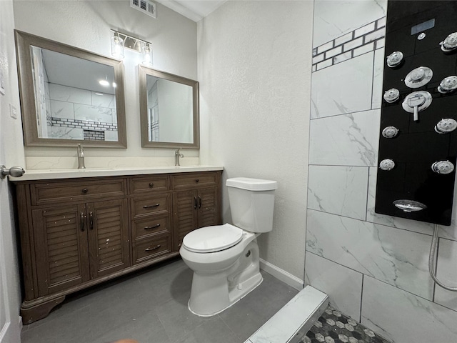 bathroom featuring tile patterned floors, a shower, vanity, and toilet