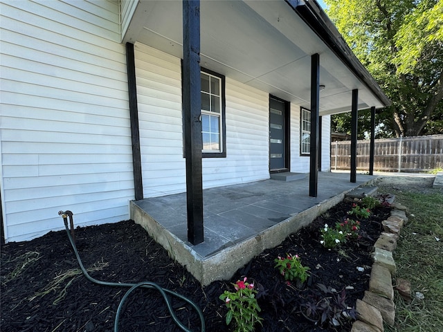 view of side of property featuring covered porch